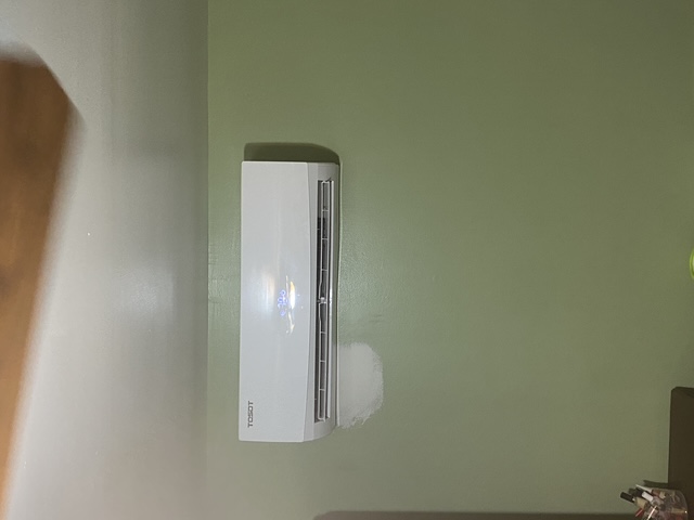Indoor ductless mini-split system mounted on a wall